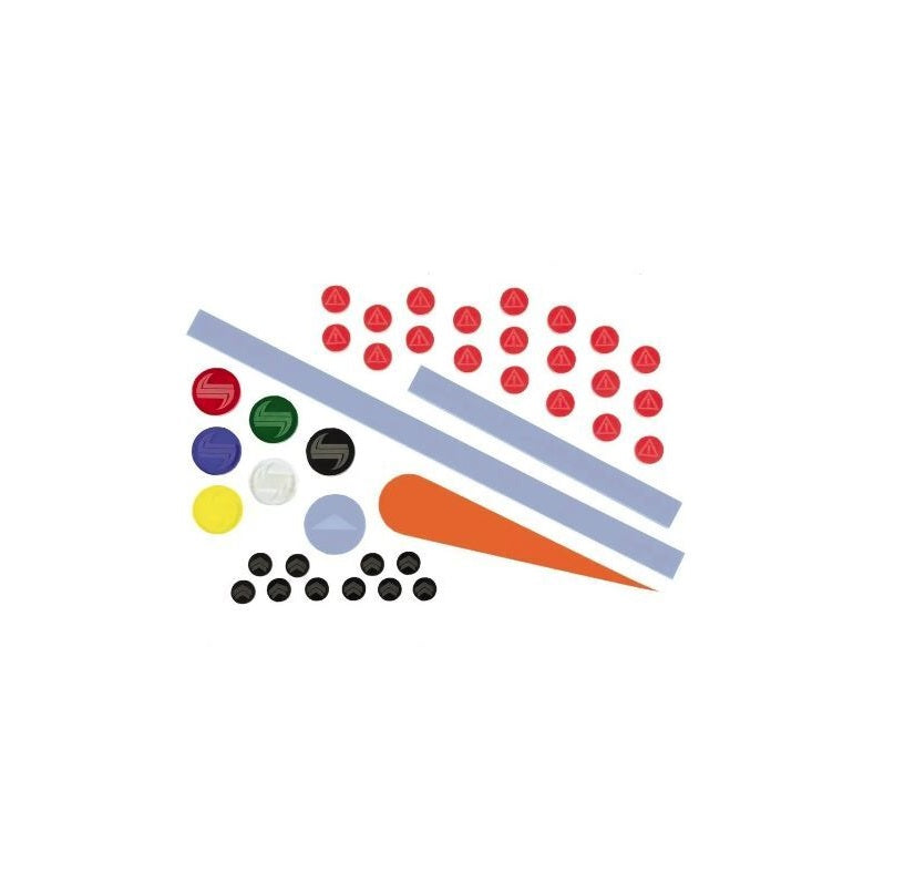 Diverse game pieces: red warning triangles, multi-colored S-logo tokens, grey bars, an orange wedge, blue circle, and black chevrons.