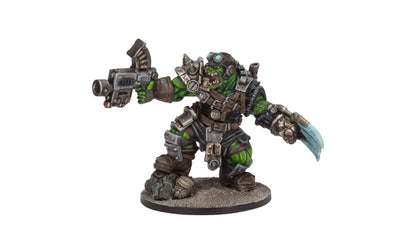 A painted miniature of a green-skinned armored orc, holding a futuristic gun and a large blue blade