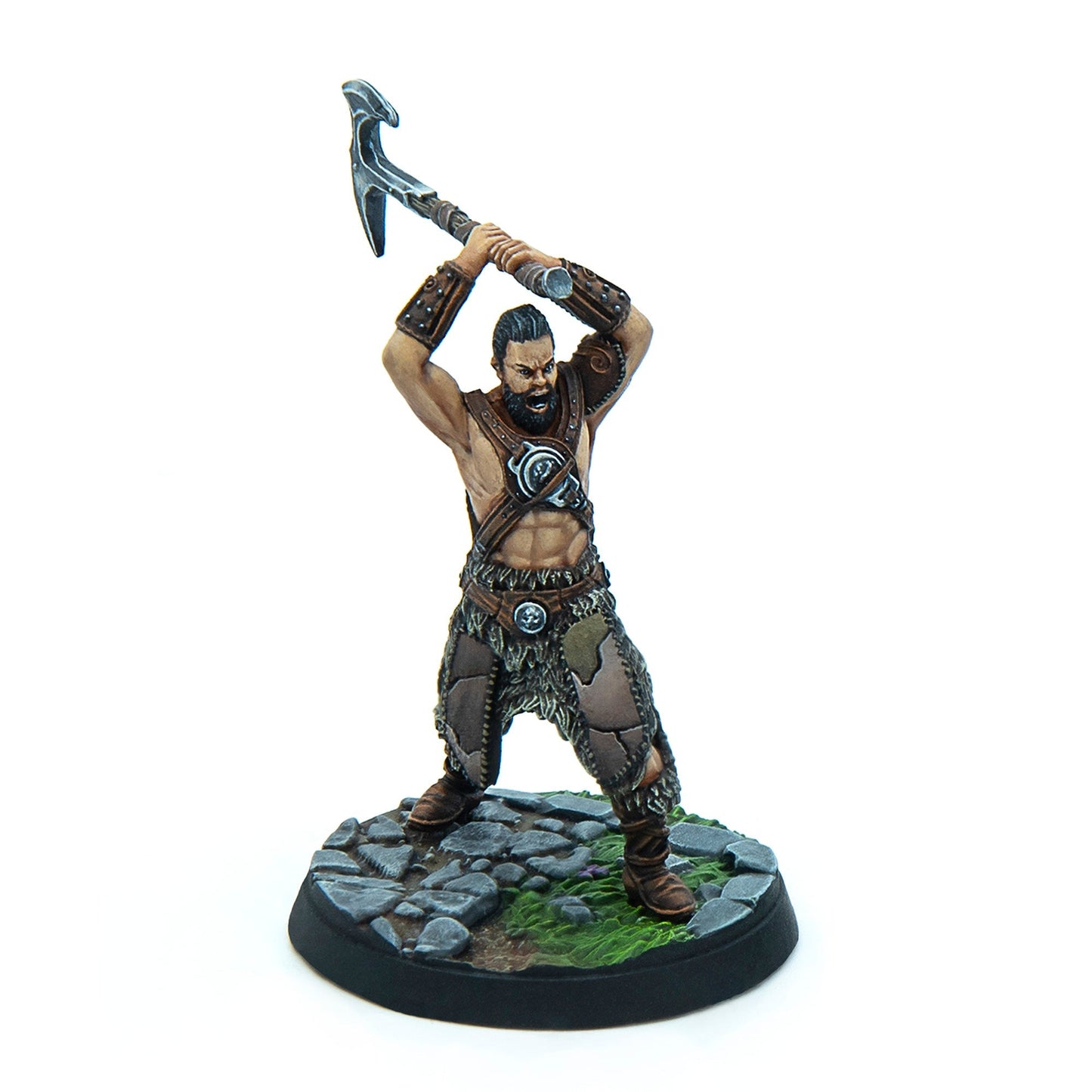 A painted miniature of a bearded barbarian warrior raising a war pick overhead, roaring, on a stone base