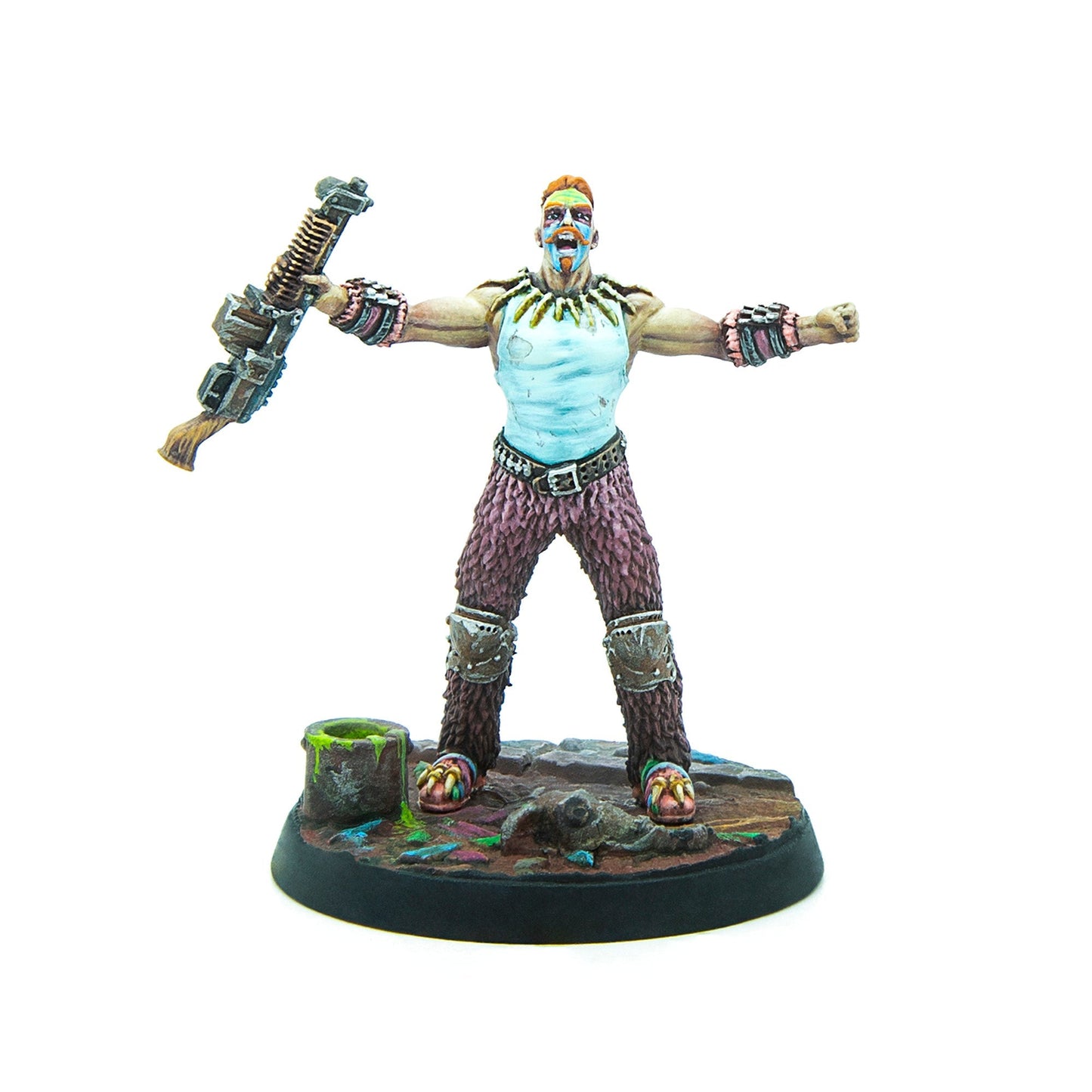 A painted miniature man with a red mohawk and war paint, arms outstretched, mouth open, holding a weapon