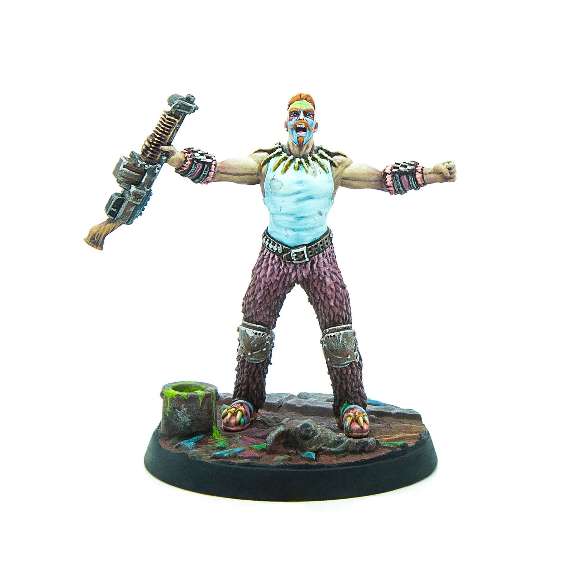 A painted miniature man with a red mohawk and war paint, arms outstretched, mouth open, holding a weapon