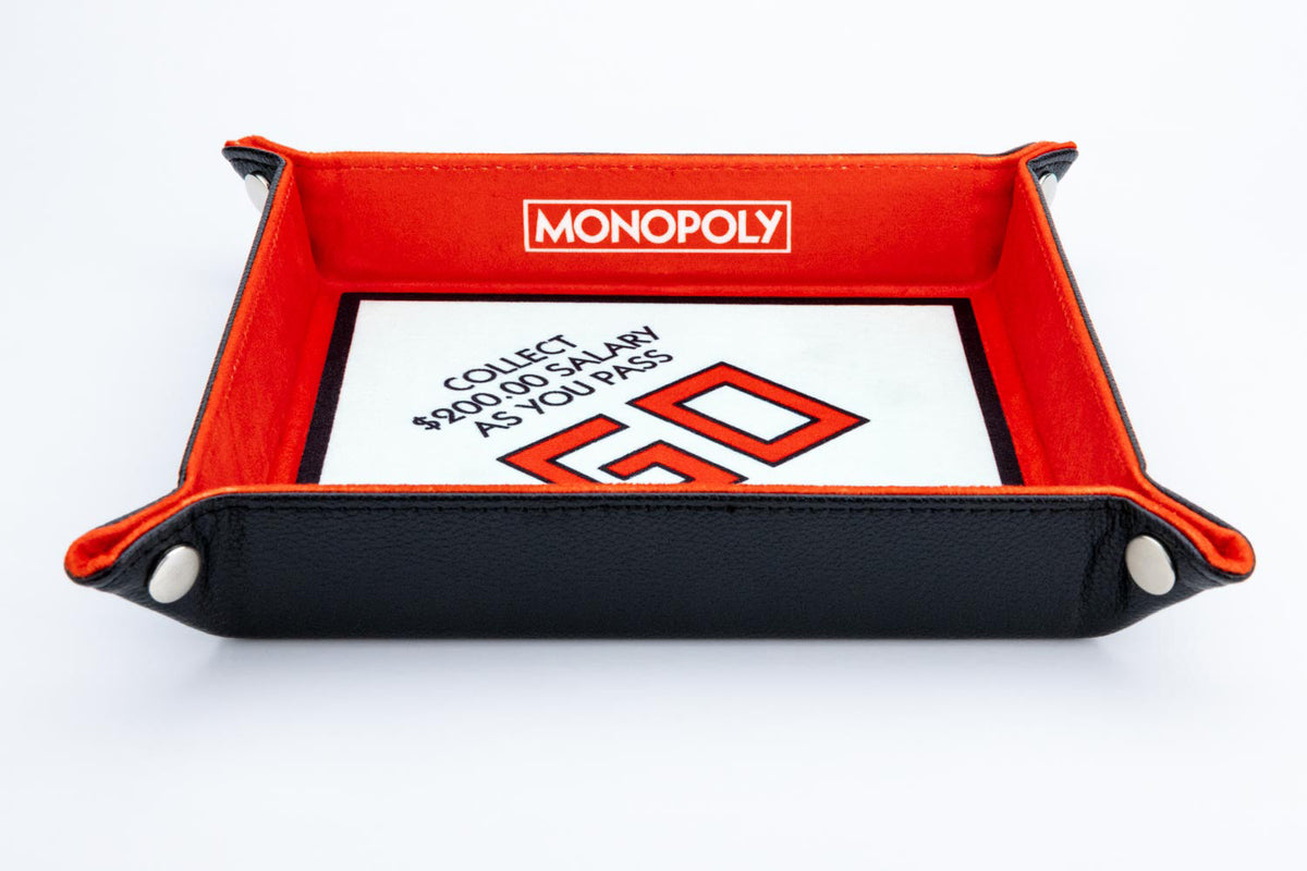 Black and red Monopoly dice tray displays &quot;COLLECT $200.00 SALARY AS YOU PASS GO&quot;