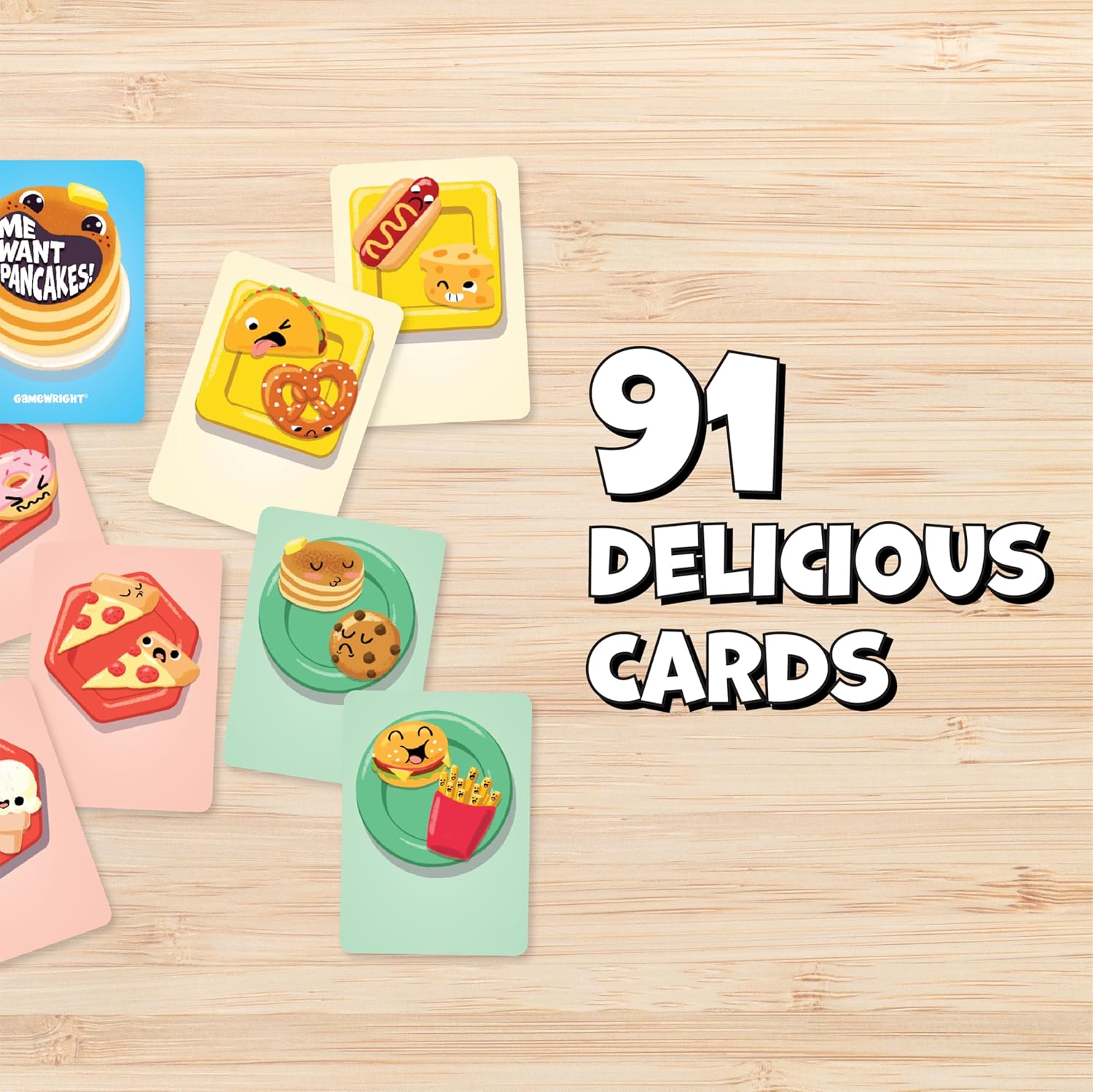 Gamewright game cards with cartoon food, including pancakes and pizza, spread on a wooden table. Text: 91 DELICIOUS CARDS