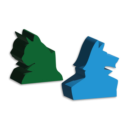 Two extruded board game tokens: a green stylized animal head and a blue stylized animal head