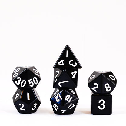 Black metal polyhedral dice set with silver numbering on dark background D20, D12, D10, D8, D6, and D4 shown