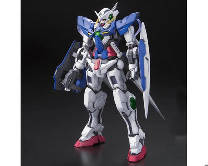 White and blue Gundam model stands holding a rifle and shield on a dark background