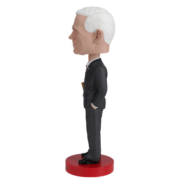 Royal Bobbles Mike Pence bobblehead figurine in a dark suit on a red base side view