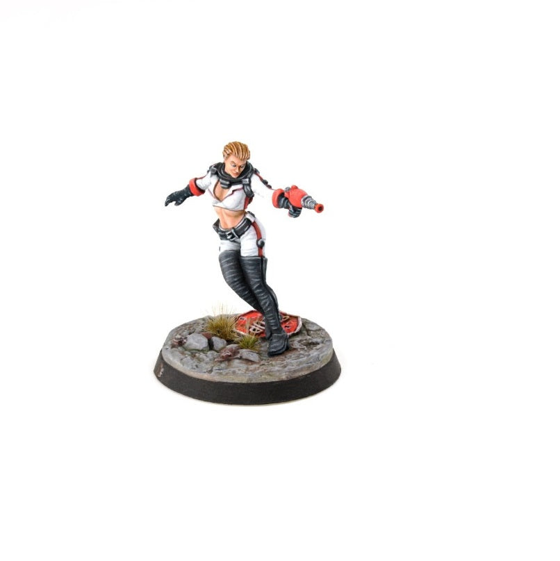 A painted miniature of a blonde woman in a white sci-fi suit, holding a red blaster, dynamically posed on a rubble base.