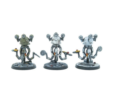 Three weathered, multi-eyed robot miniatures (green, white, light blue), each holding a hotdog on a serving tray.