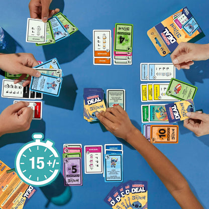 Overhead shot of players using Disney Monopoly Deal Stitch card game featuring character cards and property sets spread across a blue surface