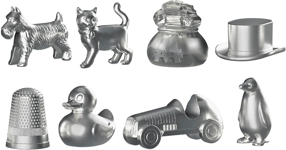 Collection of eight shiny silver Monopoly tokens: Scottie dog, cat, money bag, top hat, thimble, rubber duck, race car, and penguin