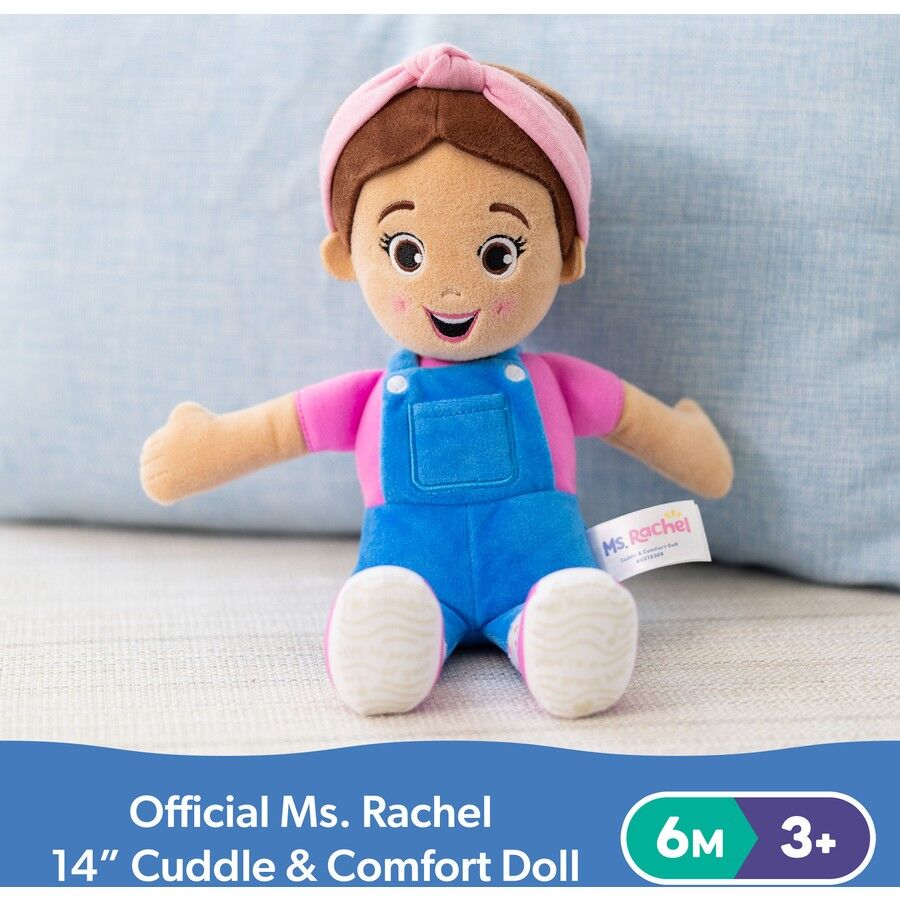 Official Ms. Rachel 14" Cuddle & Comfort plush doll sitting, wearing a pink shirt, blue overalls, and a pink headband, with a friendly smile