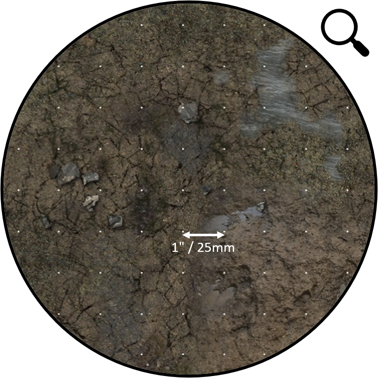Circular view of cracked, damp earth with small rocks, a grid of white dots, and a 1&quot; / 25mm scale.