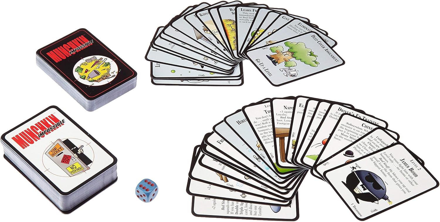 Munchkin Impossible board game components laid out: two decks, fanned game cards, and a blue die