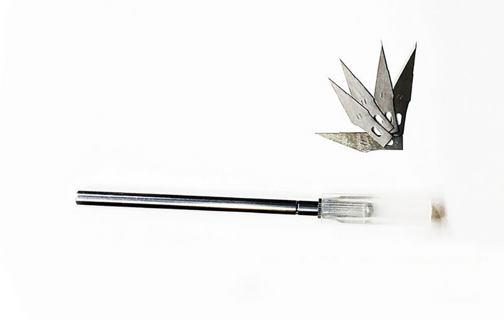 Craft knife handle and five sharp, pointed replacement blades on a white background