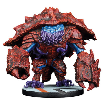 A monster miniature with dark red, spiked armor, blue skin, four eyes, and purple face tentacles, standing on a base