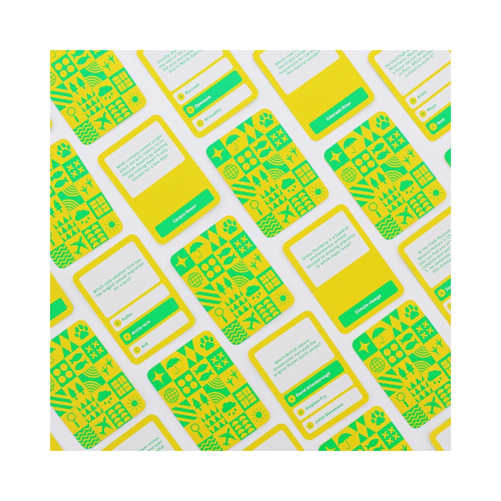 Scattered yellow and green nature explorer trivia cards show questions, answers, and various environmental icons