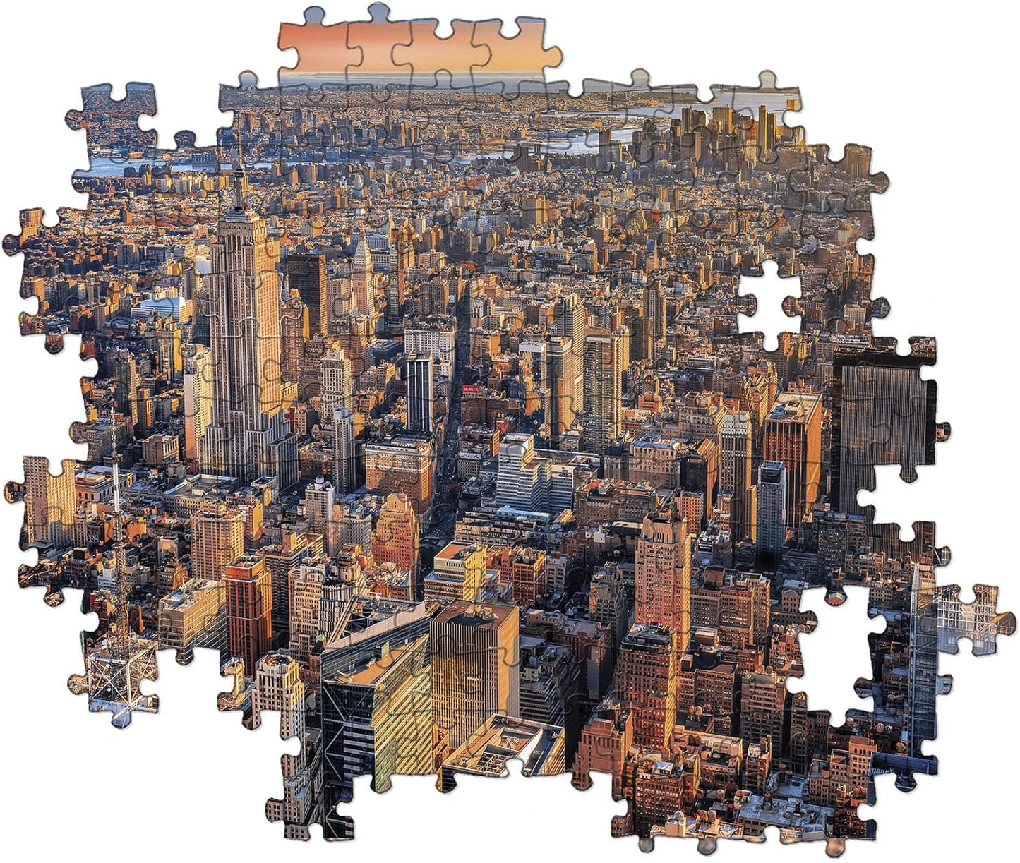 Jigsaw puzzle of an aerial New York City skyline at sunset, showing the Empire State Building and missing pieces.