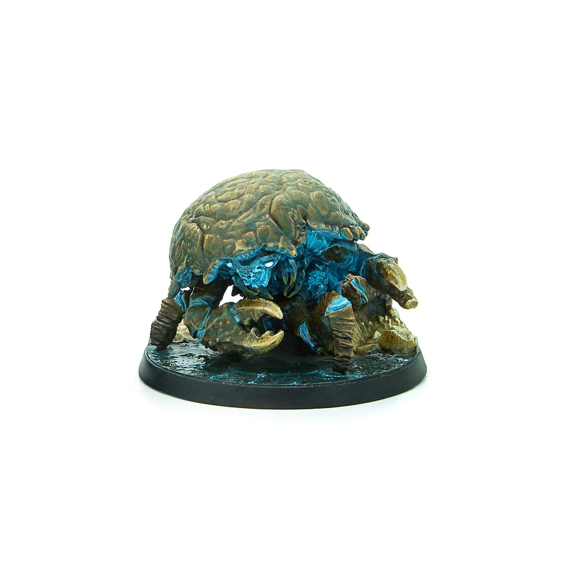 Crab-like miniature with a textured shell, glowing blue eyes and underside, standing on a dark, wet base