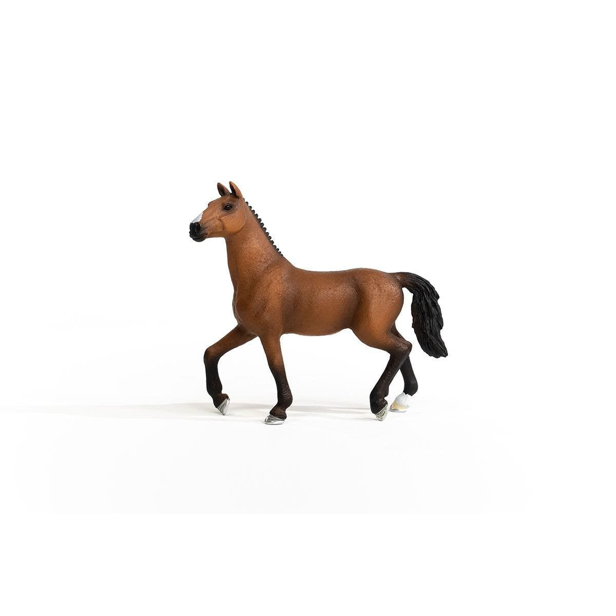 Bay horse figurine with white blaze, black mane and tail, trotting against a white background