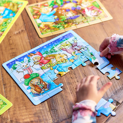 Child's hands assembling a winter-themed puzzle featuring cartoon rabbits and a snowman