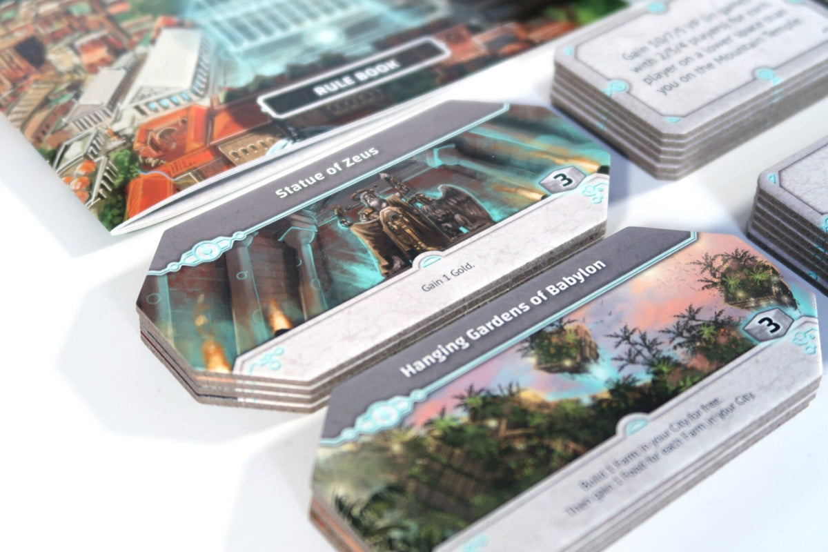 Origins: Ancient Wonders cards, tokens, and game pieces spread on table