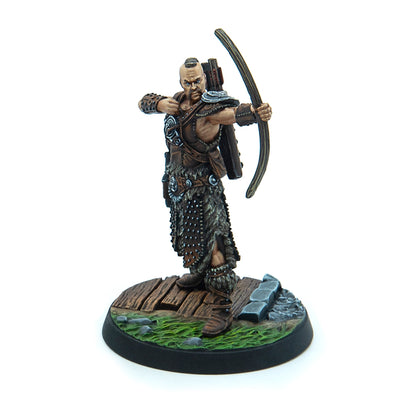 Miniature fantasy archer with a mohawk, in leather and fur armor, drawing a bow on a scenic base