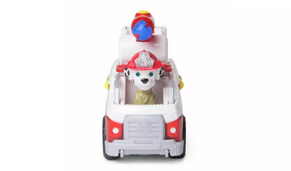 Paw Patrol Marshall Dalmatian toy in his red and white fire truck with a red fire helmet and blue water cannon