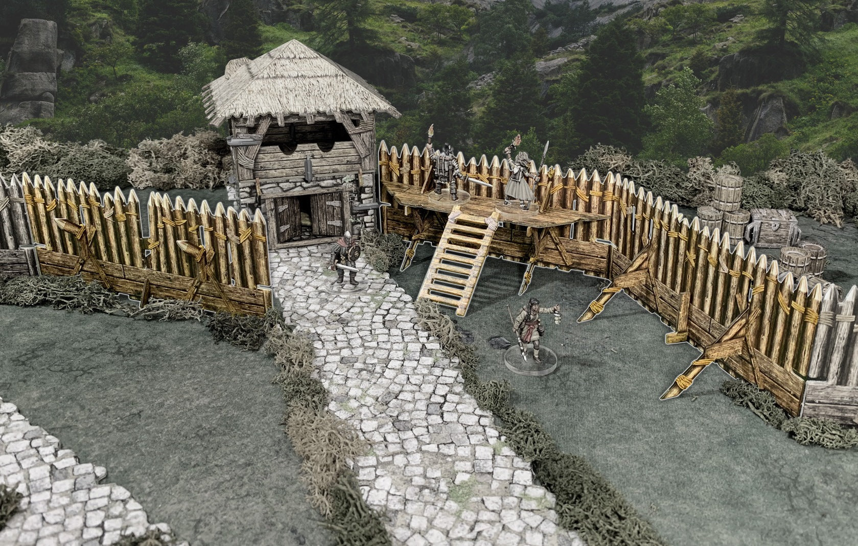 A tabletop game: A fortified wooden outpost with a thatched building and palisade, featuring miniature warriors and adventurers on a path.