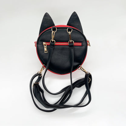 Black and red cat-eared mini backpack with gold zippers and straps, seen from the back on a white background.
