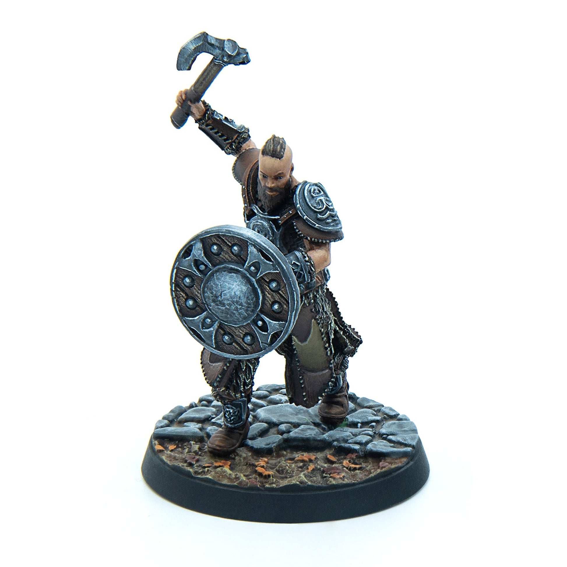 Fierce armored warrior miniature, dark-skinned with a beard and mohawk, raising an axe and holding a shield