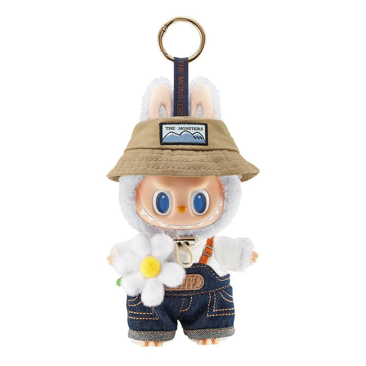 White monster character keychain with bunny ears, bucket hat, denim overalls, holding a white daisy