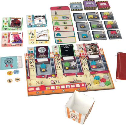 Overhead view of a cinema-themed Popcorn board game laid out, showing its movie theater game board, cards, meeples, and a popcorn box