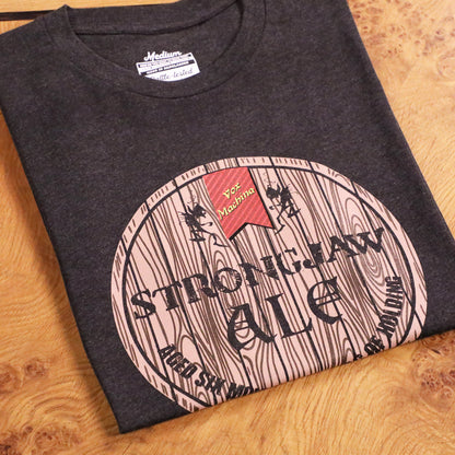 Dark grey t-shirt featuring a 'Strongjaw Ale' barrel graphic with imps, a 'Vox Machina' banner. Folded on wood