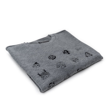 Folded grey t-shirt with a pattern of small black outline cartoon faces