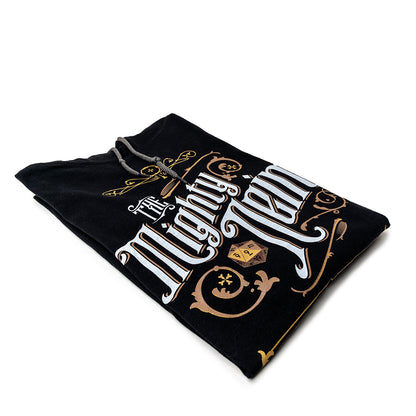Folded black hoodie with "The Mighty Nein" text, d20, scissors, and comb design in white and gold