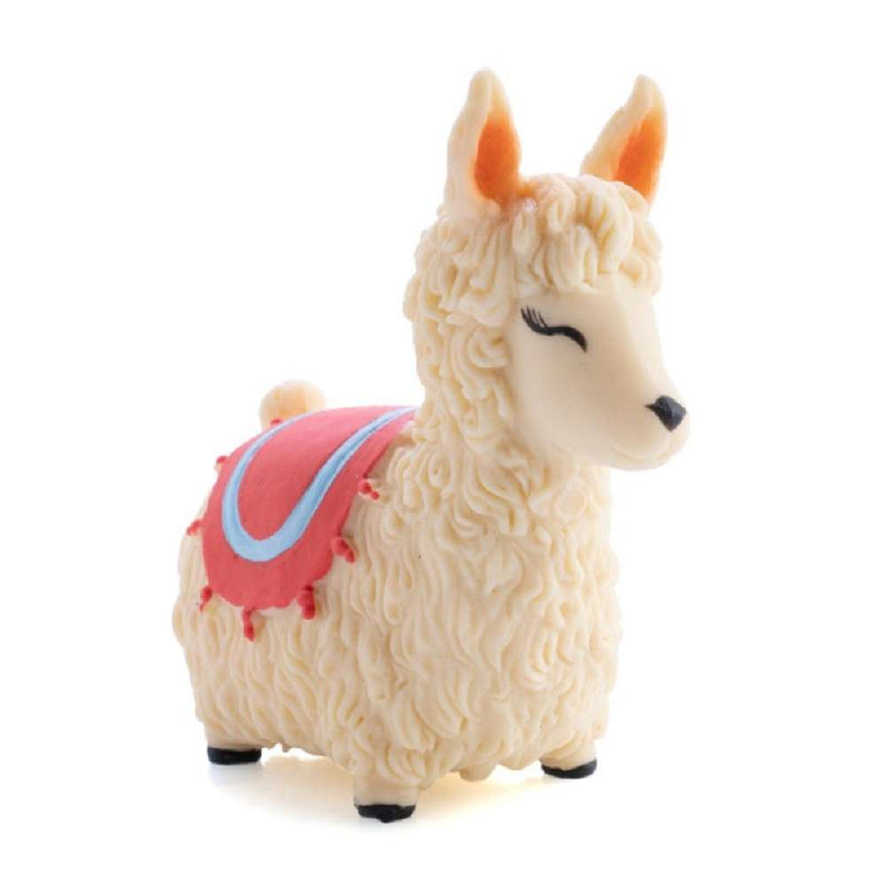 Cream toy llama figurine with sculpted fur and a pink decorative blanket, isolated on white