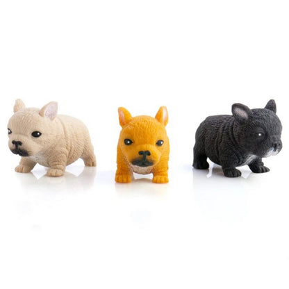 Three French Bulldog puppy figurines: tan, orange, and black, on a white background