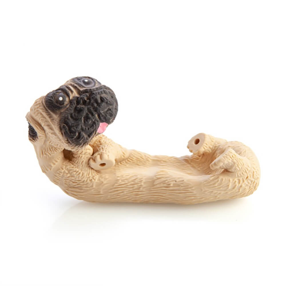 Tan pug-shaped holder lying on its back, head twisted up, black snout, pink tongue. Its body forms a trough
