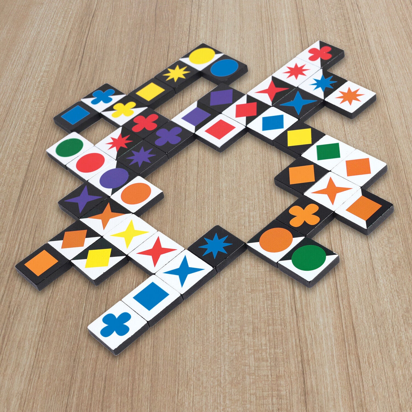 Colorful shape-matching game tiles arranged in a winding pattern on a light wood table