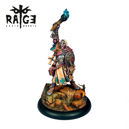 Painted fantasy miniature: hooded, armored warrior with shield, raising a glowing blue torch on a rocky base