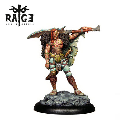 A muscular barbarian resin miniature with red hair, green tattoos, and fur cloak, holding a huge sword behind his head