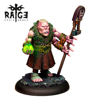 A pink-skinned Celberum Dark Rune Figure in green leaf armor and a kilt holds a glowing orb and a dark staff on a textured base
