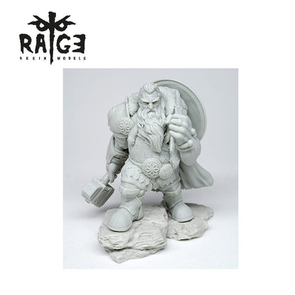 A gray resin Halsten Wolf Nose figure of a bearded warrior with a hammer and shield on rock bases