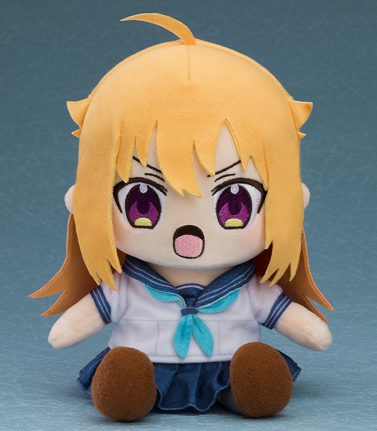 Orange-haired anime girl plush with wide purple eyes and an open mouth, wearing a white sailor uniform and blue skirt, sitting