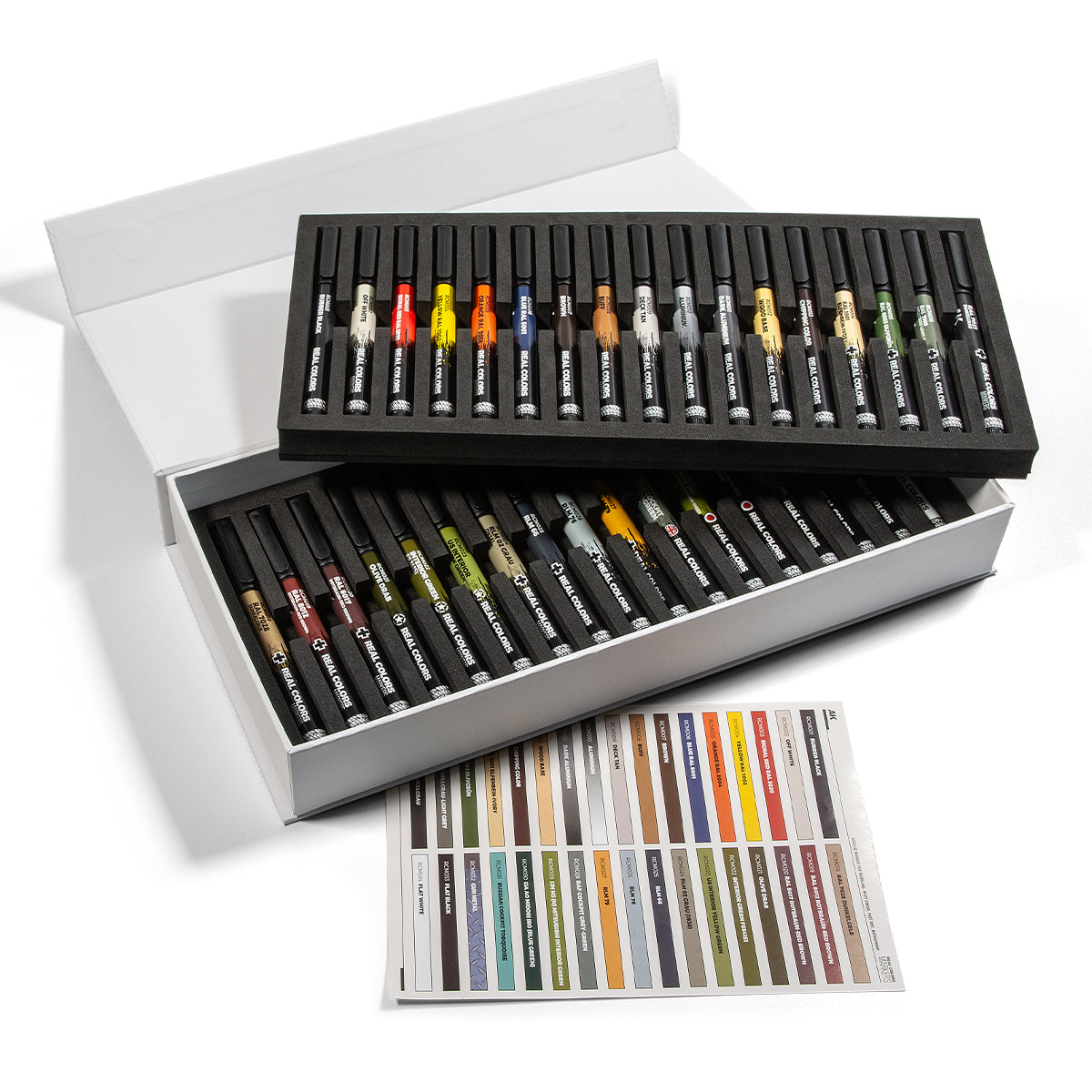 A white open box holds two foam trays of Real Colors Markers, with 34 units visible, alongside a color swatch sheet on a white background