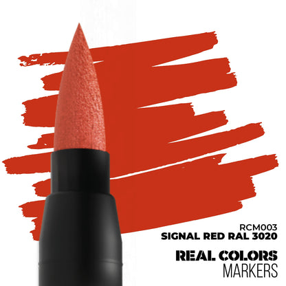 Close-up of a Signal Red marker's brush tip drawing bold red strokes on a white background