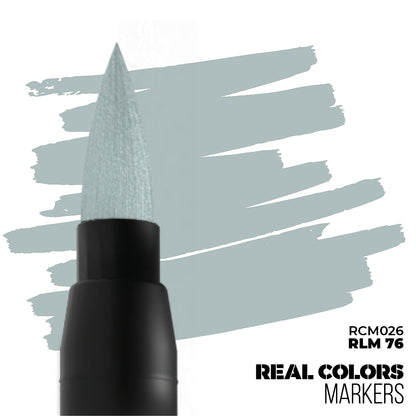A black Real Colors marker with a light blue RLM 76 brush tip, creating pale blue paint swatches