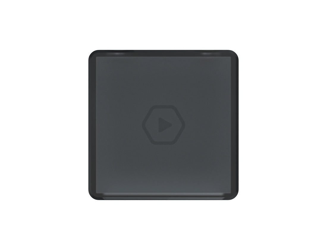 Dark gray square tile with rounded corners, featuring a subtle hexagonal play icon in the center