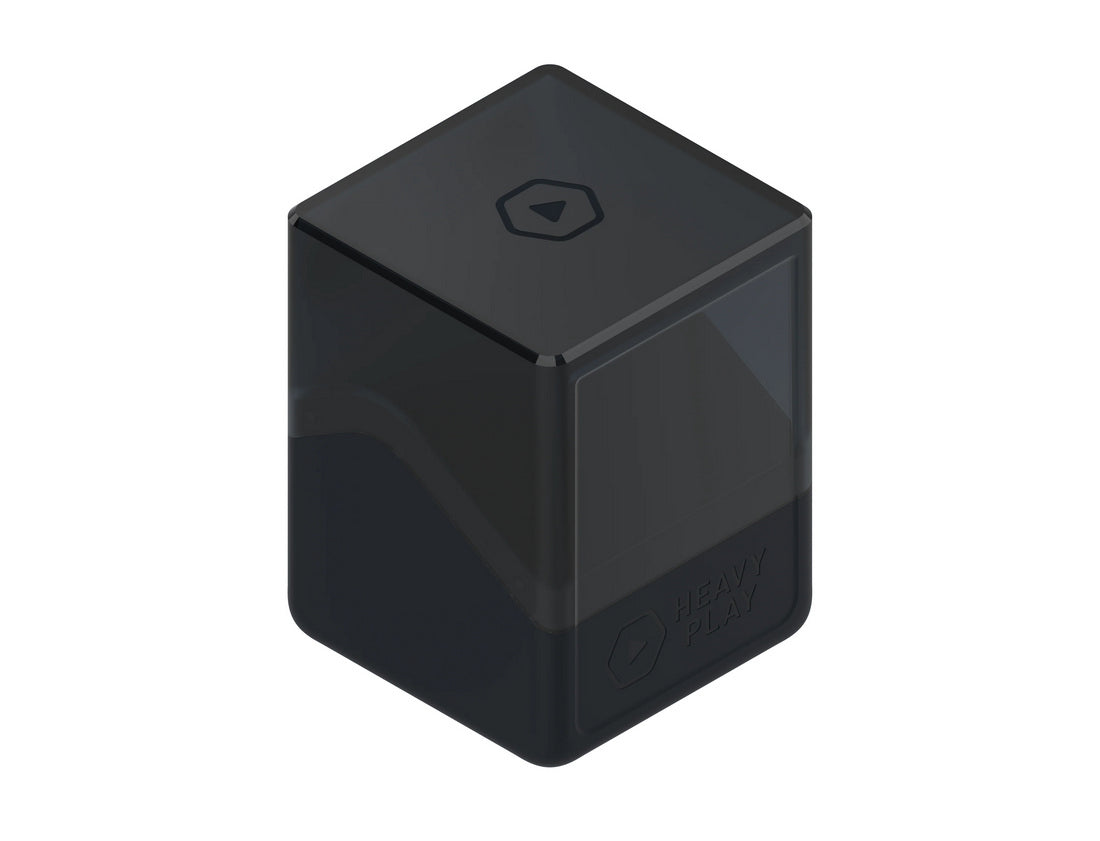Dark cuboid device, translucent upper half, featuring &#39;HEAVY PLAY&#39; text and play button icons